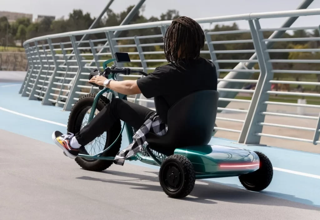 A man riding a tricycle on a bridge.