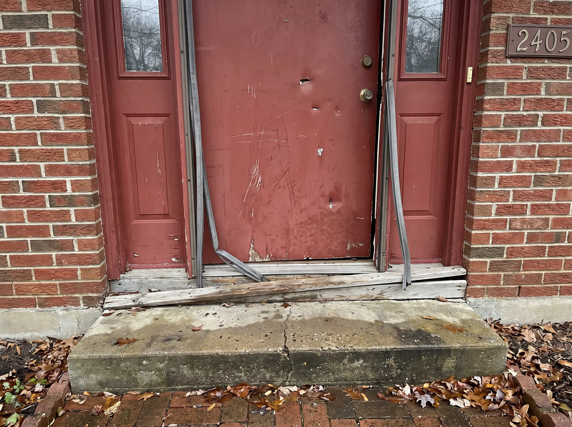 Old damaged front door with peeling paint and torn weatherstripping – O'Fallon IL area