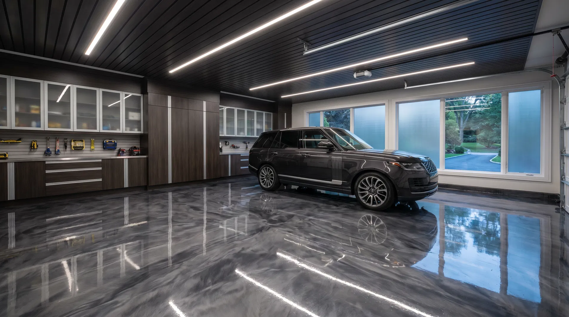 High-gloss metallic epoxy garage floor with luxury SUV, LED lighting, and organized wall cabinets
