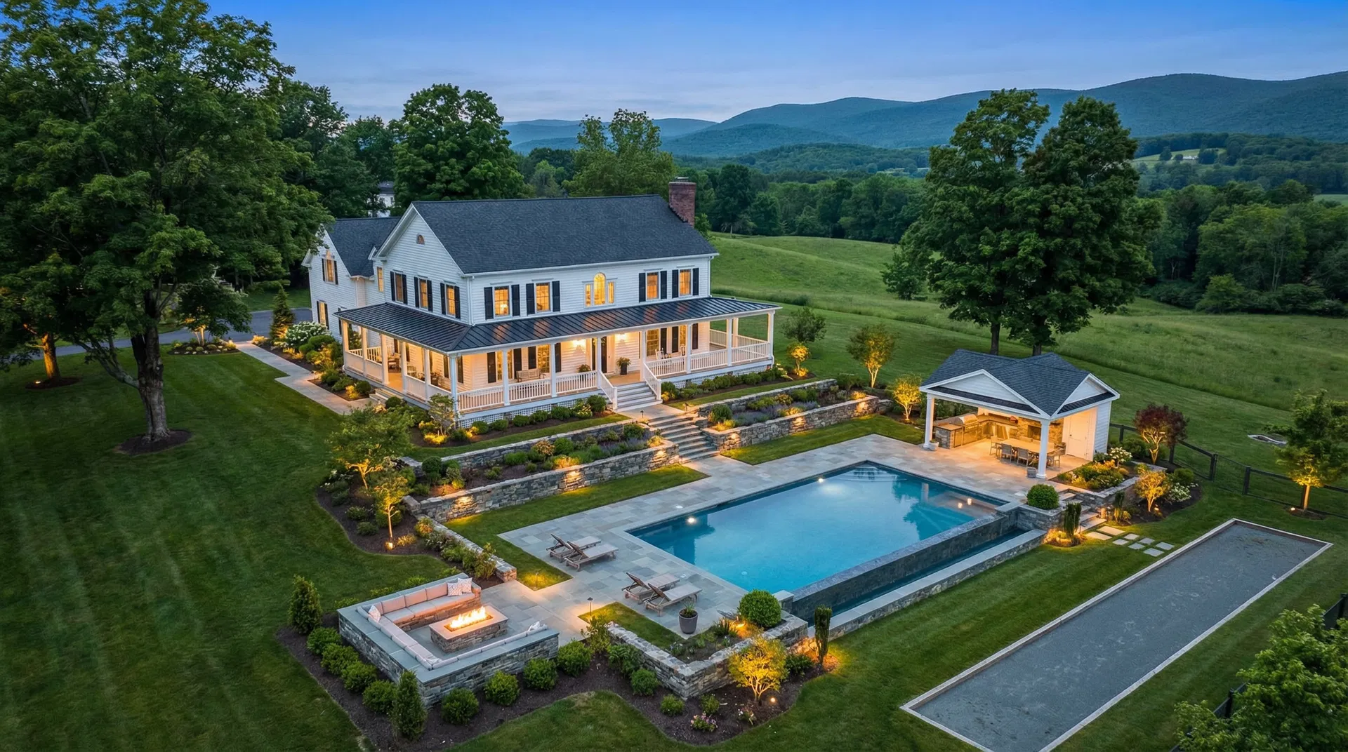 Aerial view of complete luxury outdoor living space with pool kitchen and fire pit at colonial estate Nyack NY