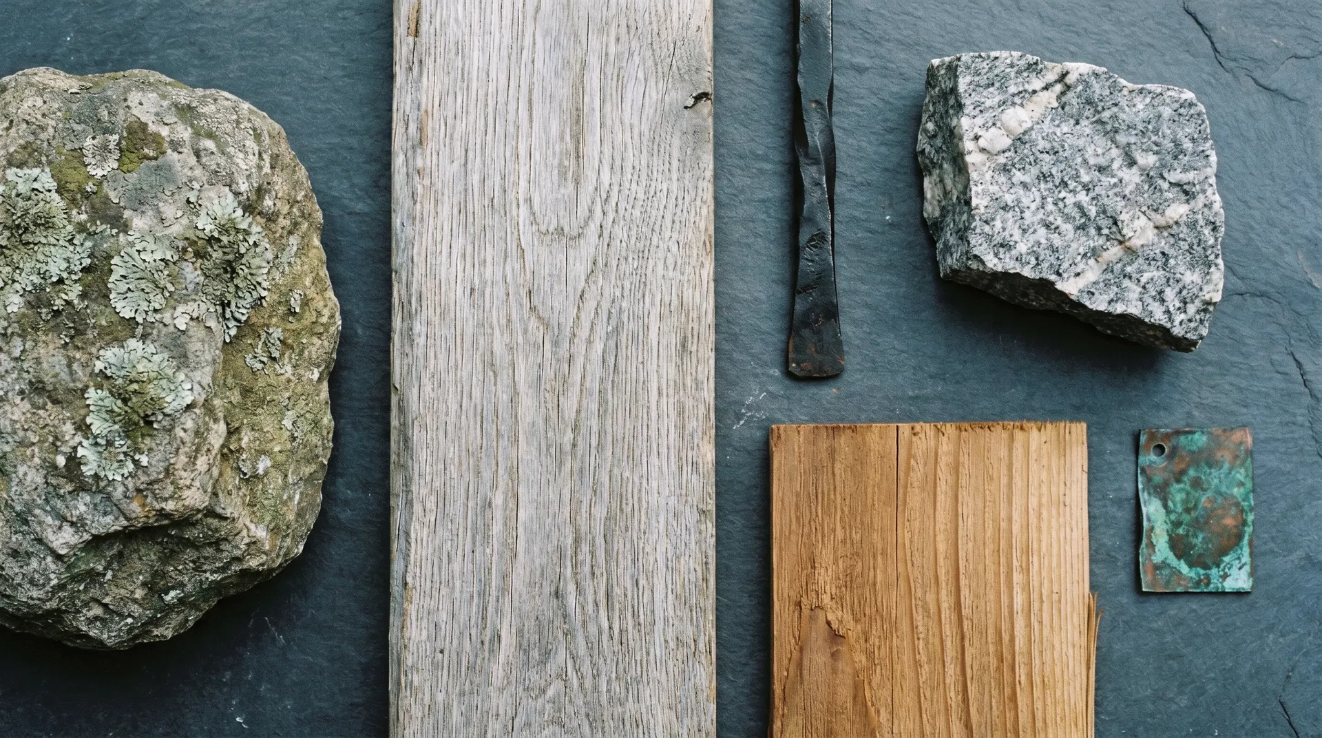 Material textures: New England fieldstone, weathered white oak, blackened iron, grey granite, oxidized copper