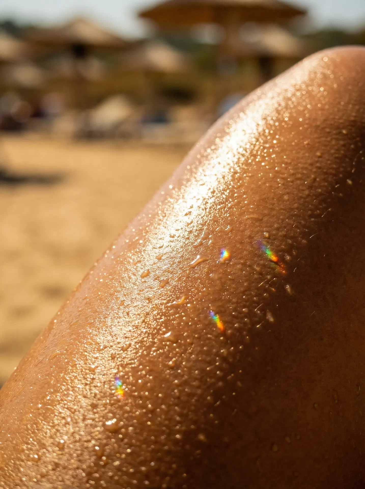 Golden tanned skin glistening with oil
