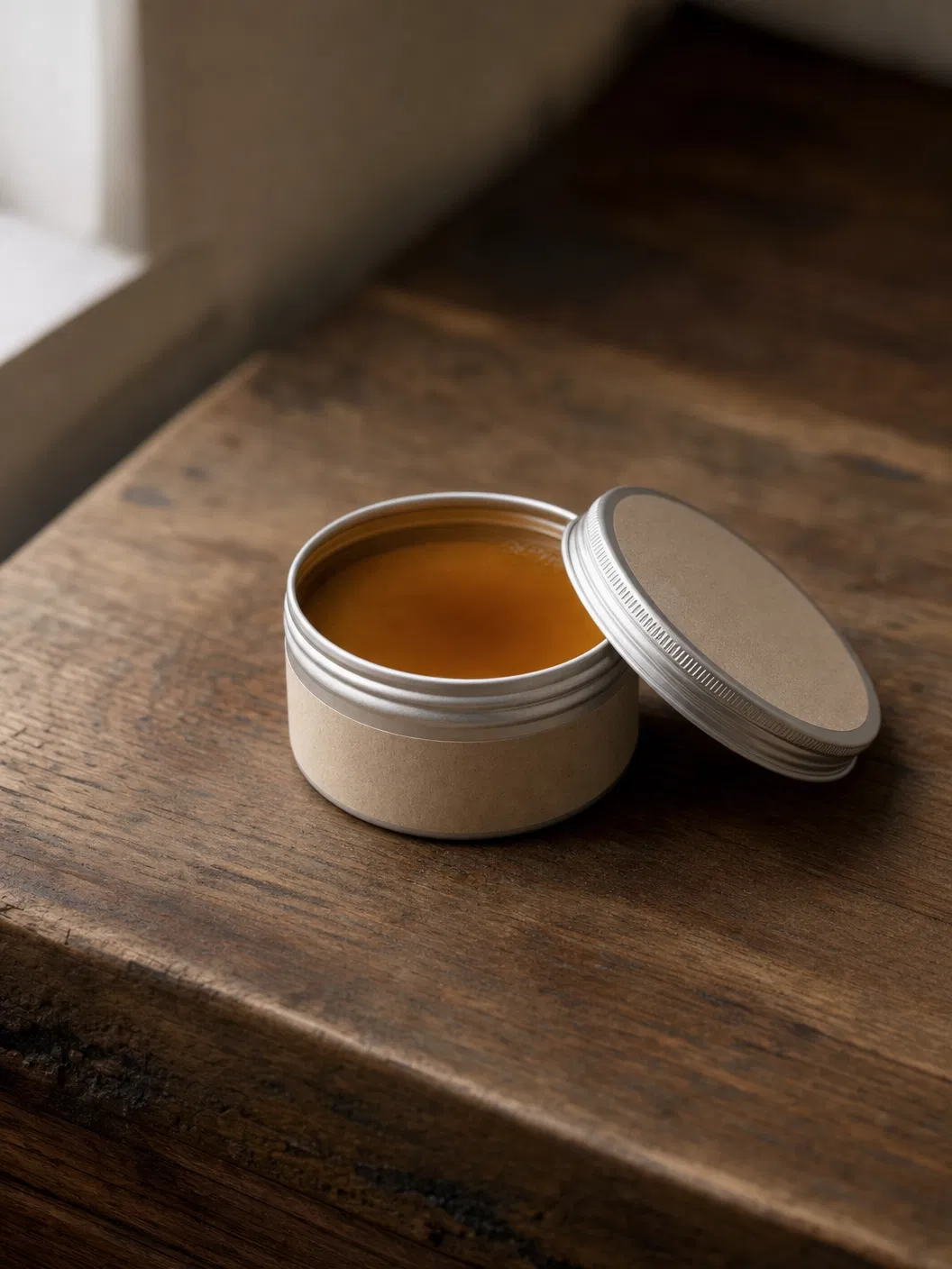 Luxgrove Wood Salve tin open on oak surface