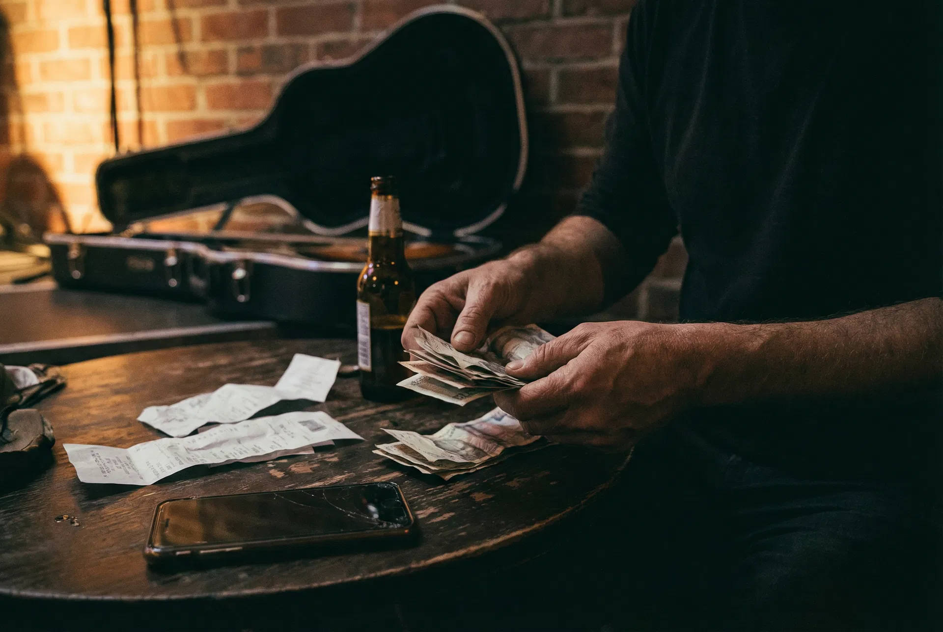 Musician counting cash backstage after a gig