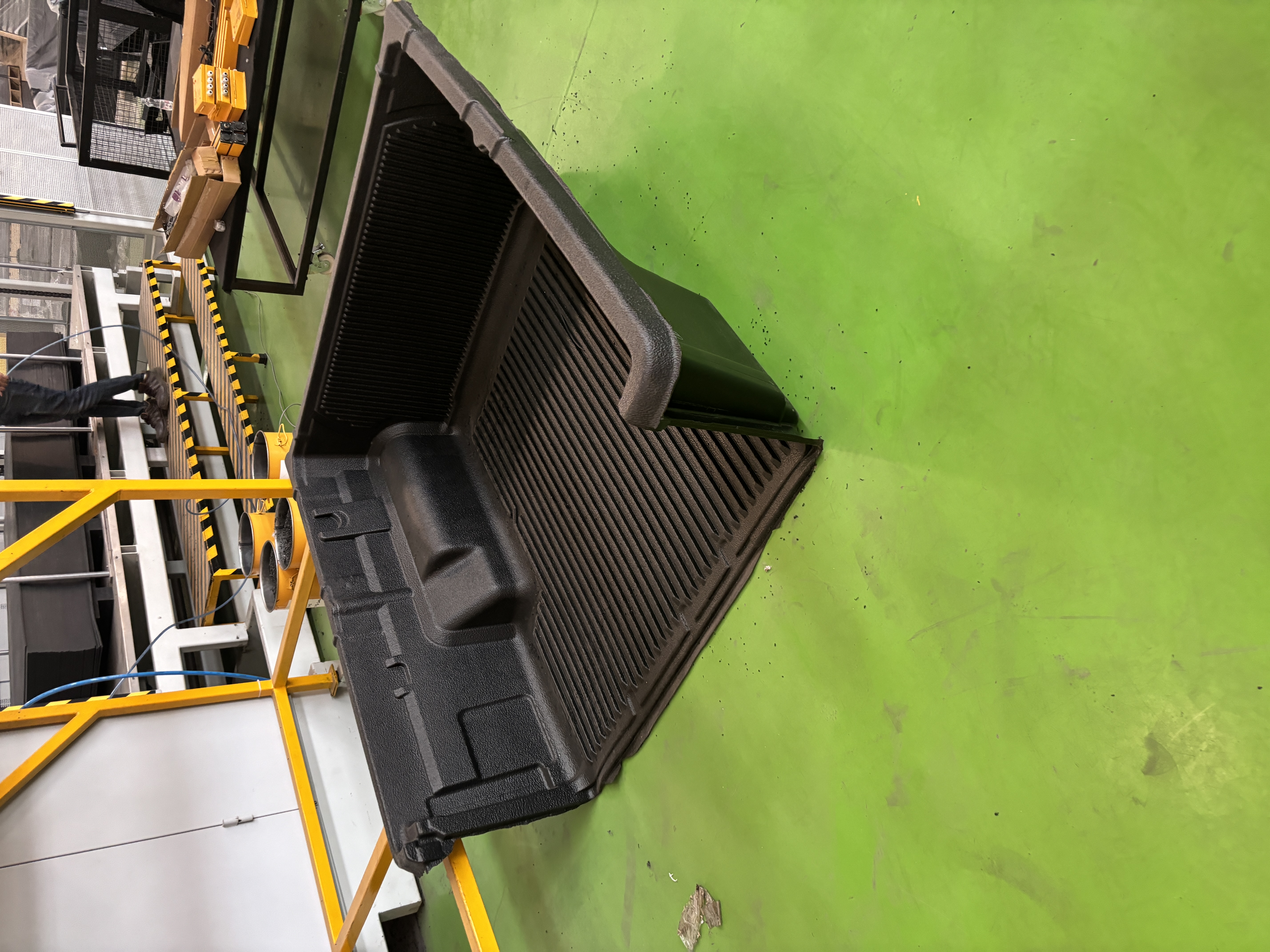 Thermoformed HDPE pickup truck bedliner for Mahindra vehicle, showcasing its custom fit and robust design.