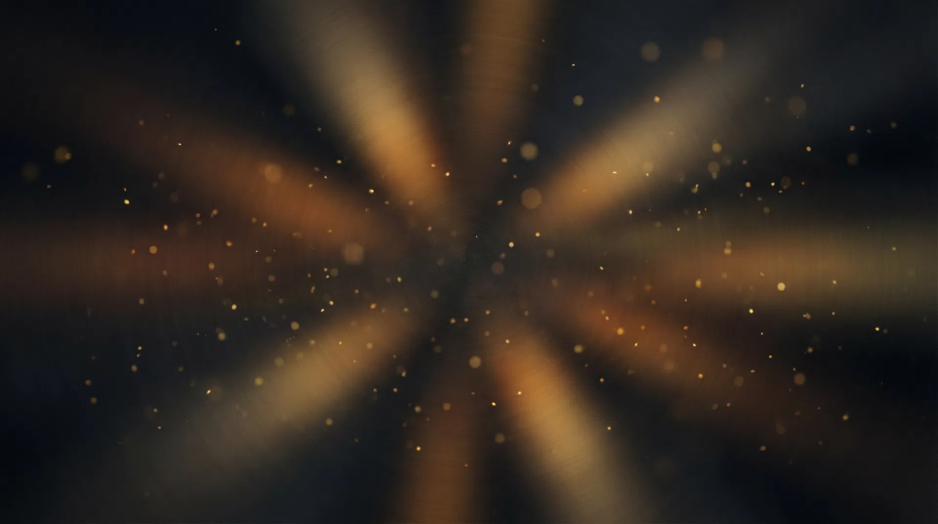 Dark abstract background with warm amber light rays