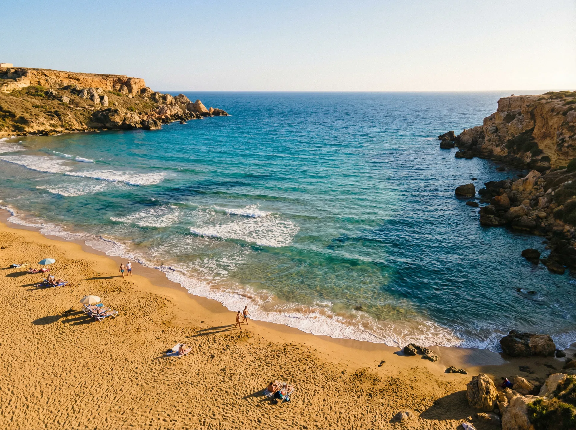 Golden Bay beach Malta with golden sand, clear blue water and dramatic limestone cliffs