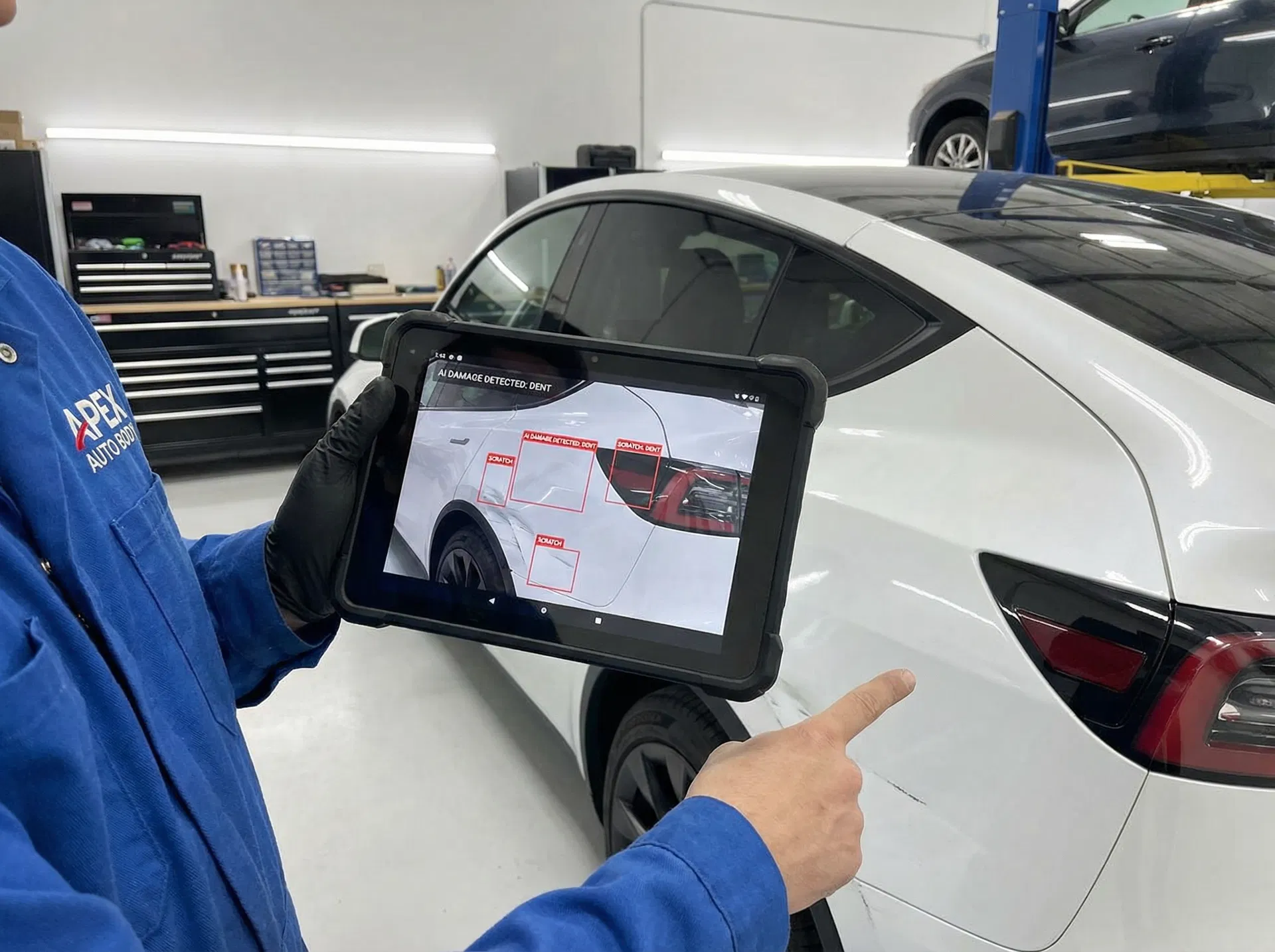 Auto body technician using AVCAPA AI damage detection on tablet