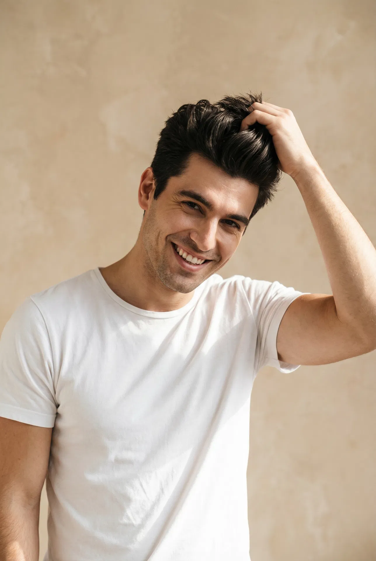 Handsome man confidently running hand through thick hair