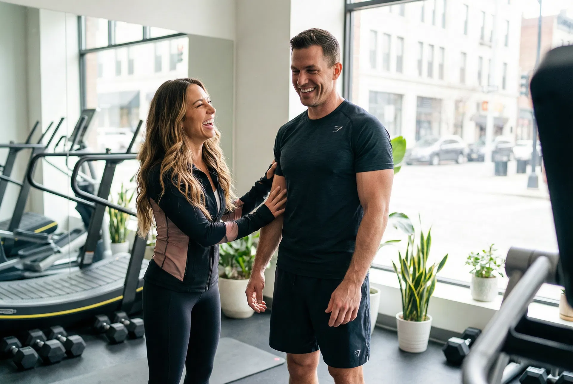 Attractive young couple in gym clothes smiling