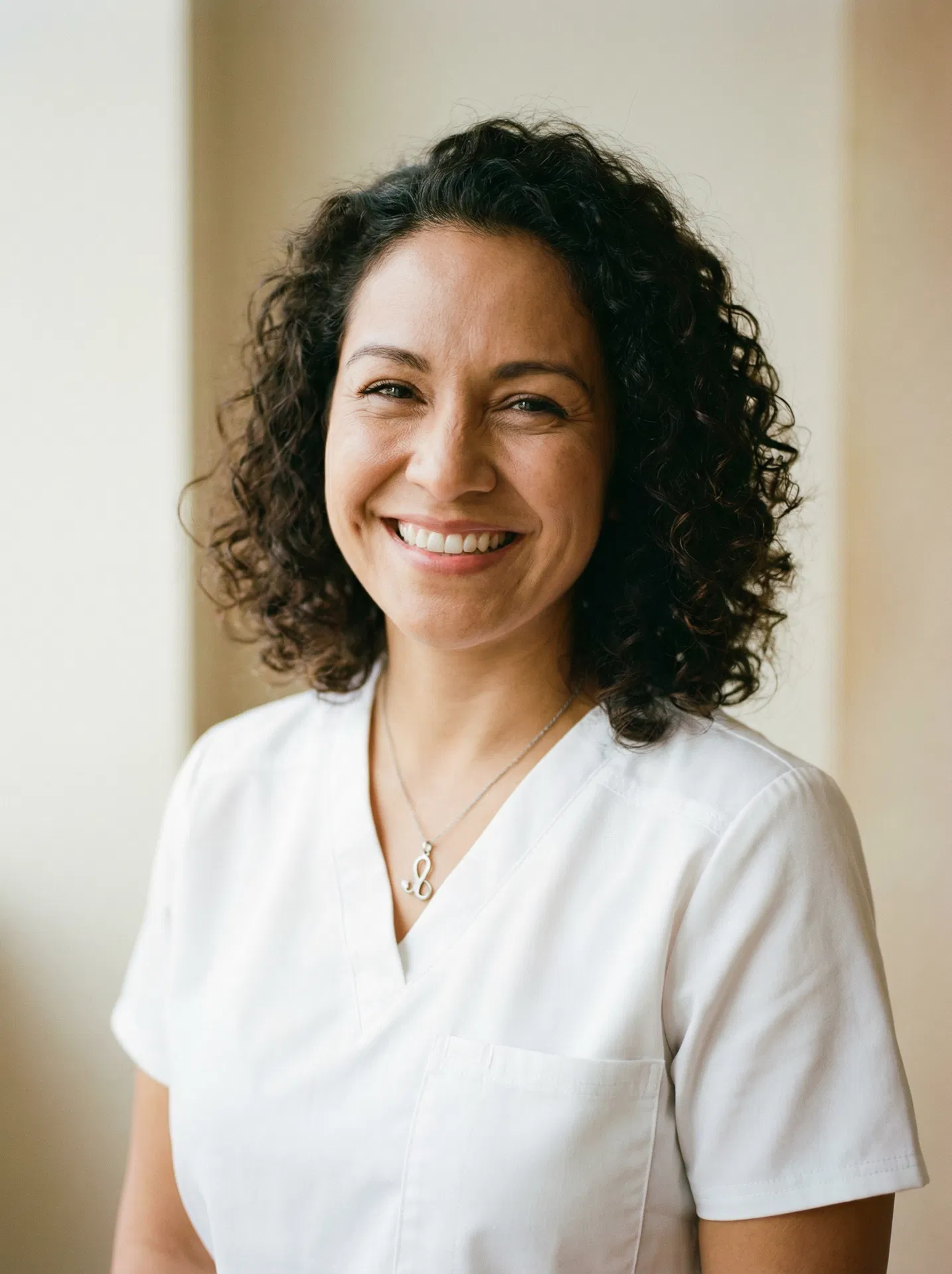 A happy, confident Latina caregiver smiling warmly