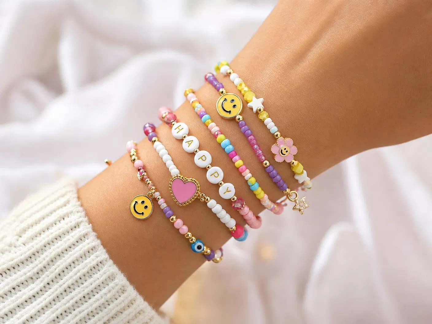Wrist wearing colorful Joy Factory bracelets