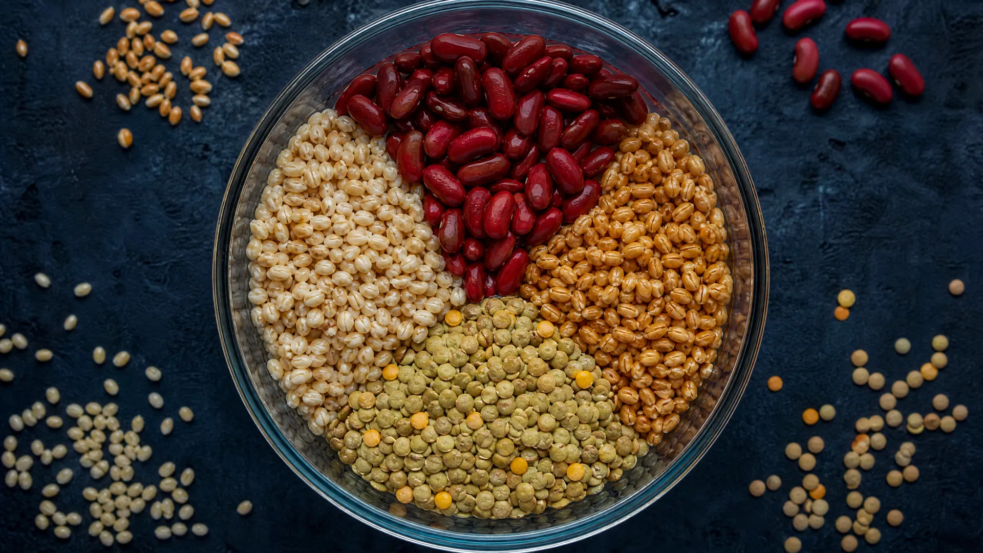 Soaked grains and legumes in glass bowl for Ezekiel bread preparation