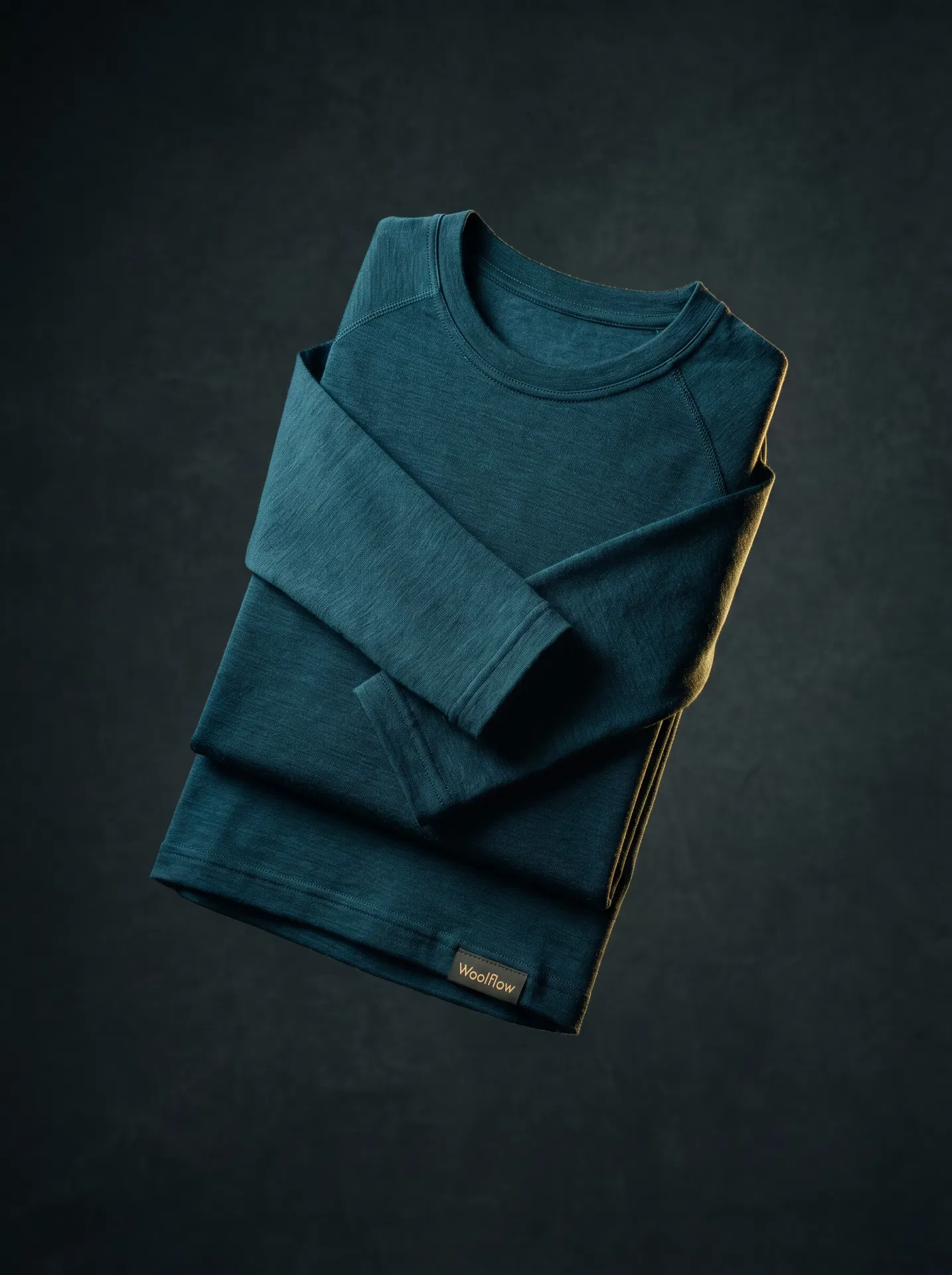 Woolflow merino teal performance top — studio product shot