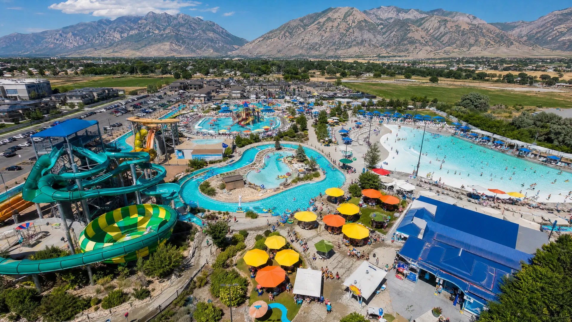 Aerial photograph of Splash Summit water park in Utah Valley with colorful slides and the Wasatch Mountains behind