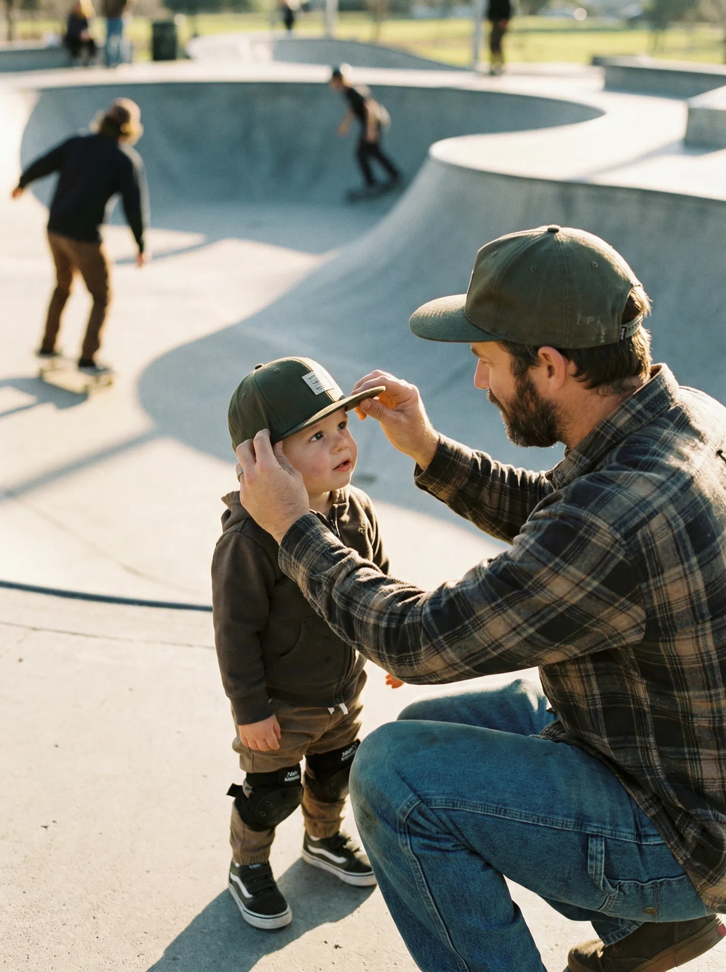 Father adjusting son's snapback at skatepark