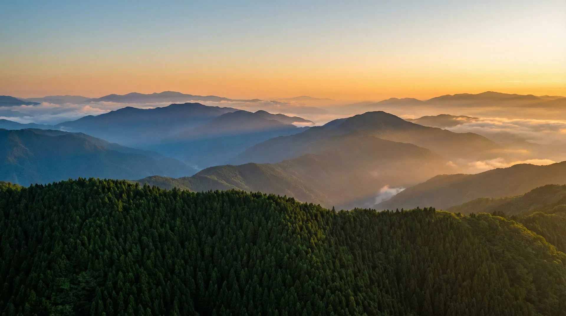 Layered Japanese mountain ridges at dawn with atmospheric haze