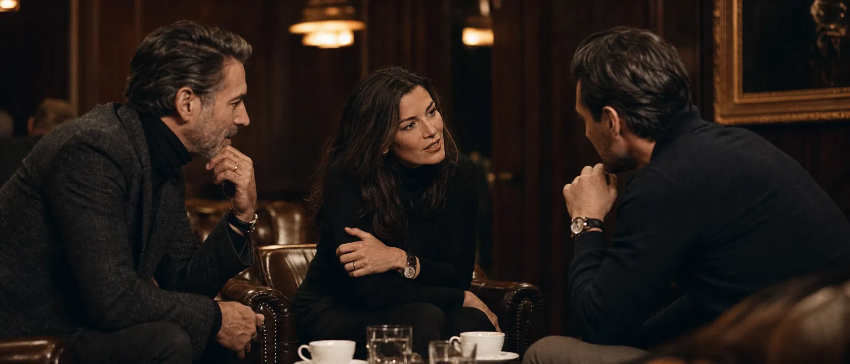 Residents in intimate conversation at a luxury private lounge — mixed group