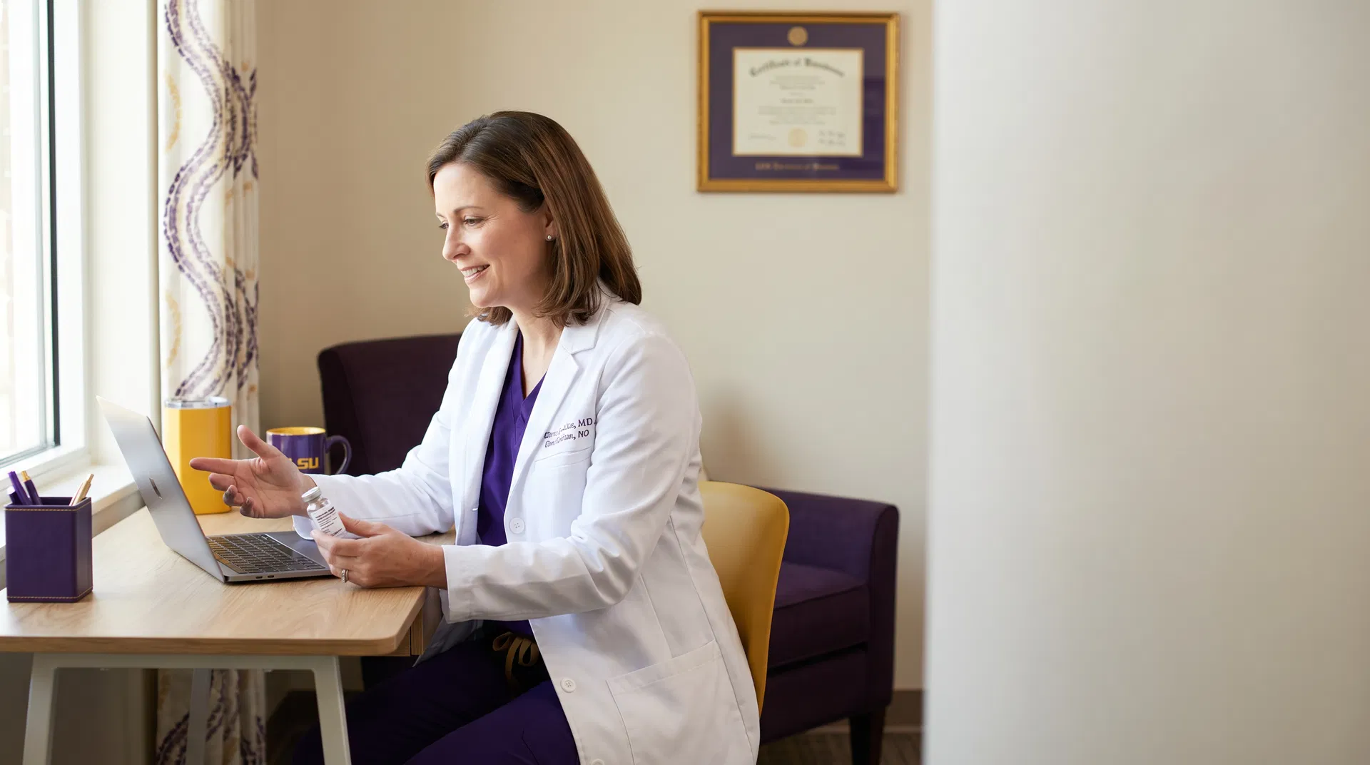 Board-certified physician on a telemedicine visit holding a biologic vial