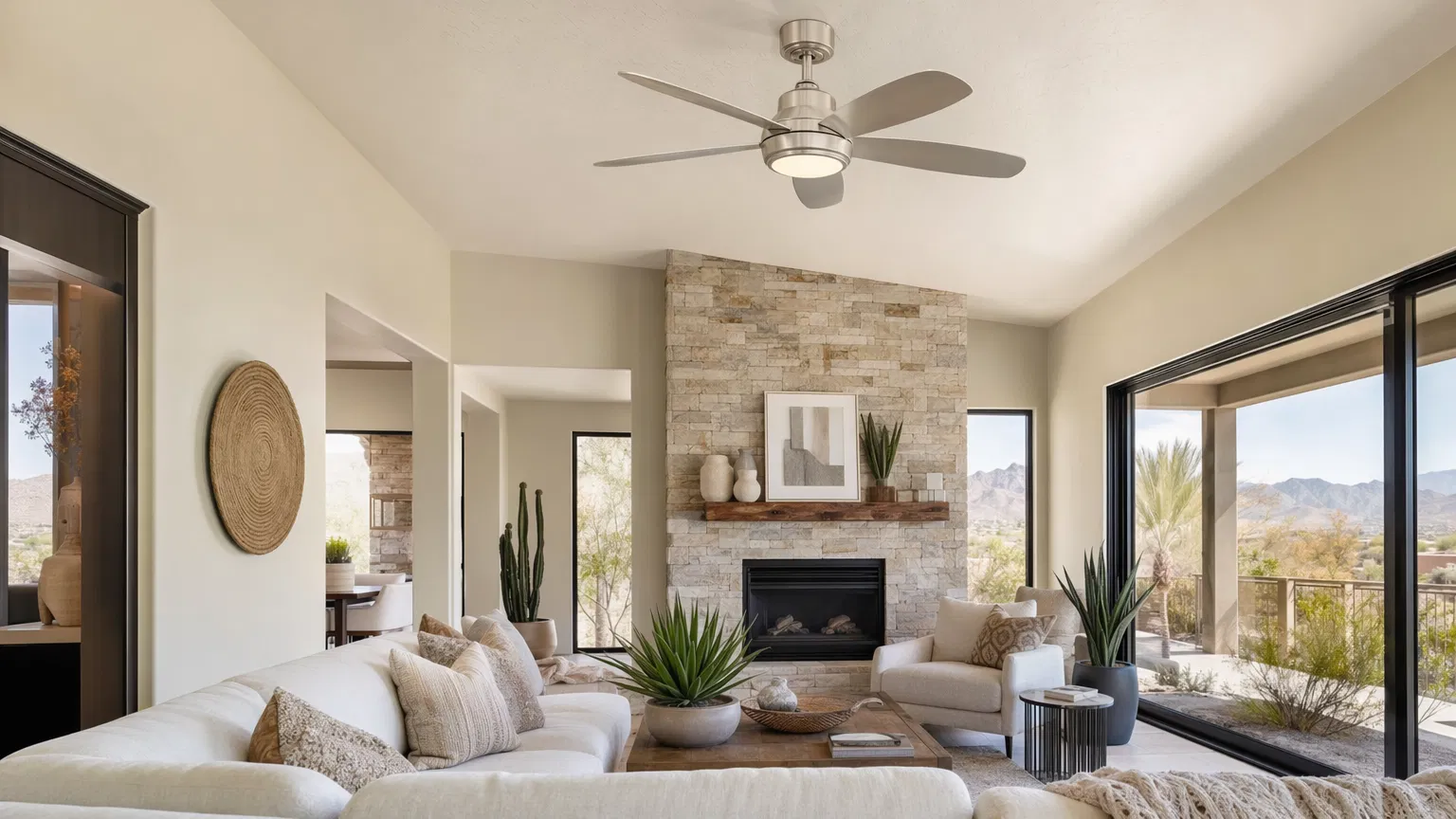 Modern brushed nickel ceiling fan in a bright Las Vegas living room with desert view