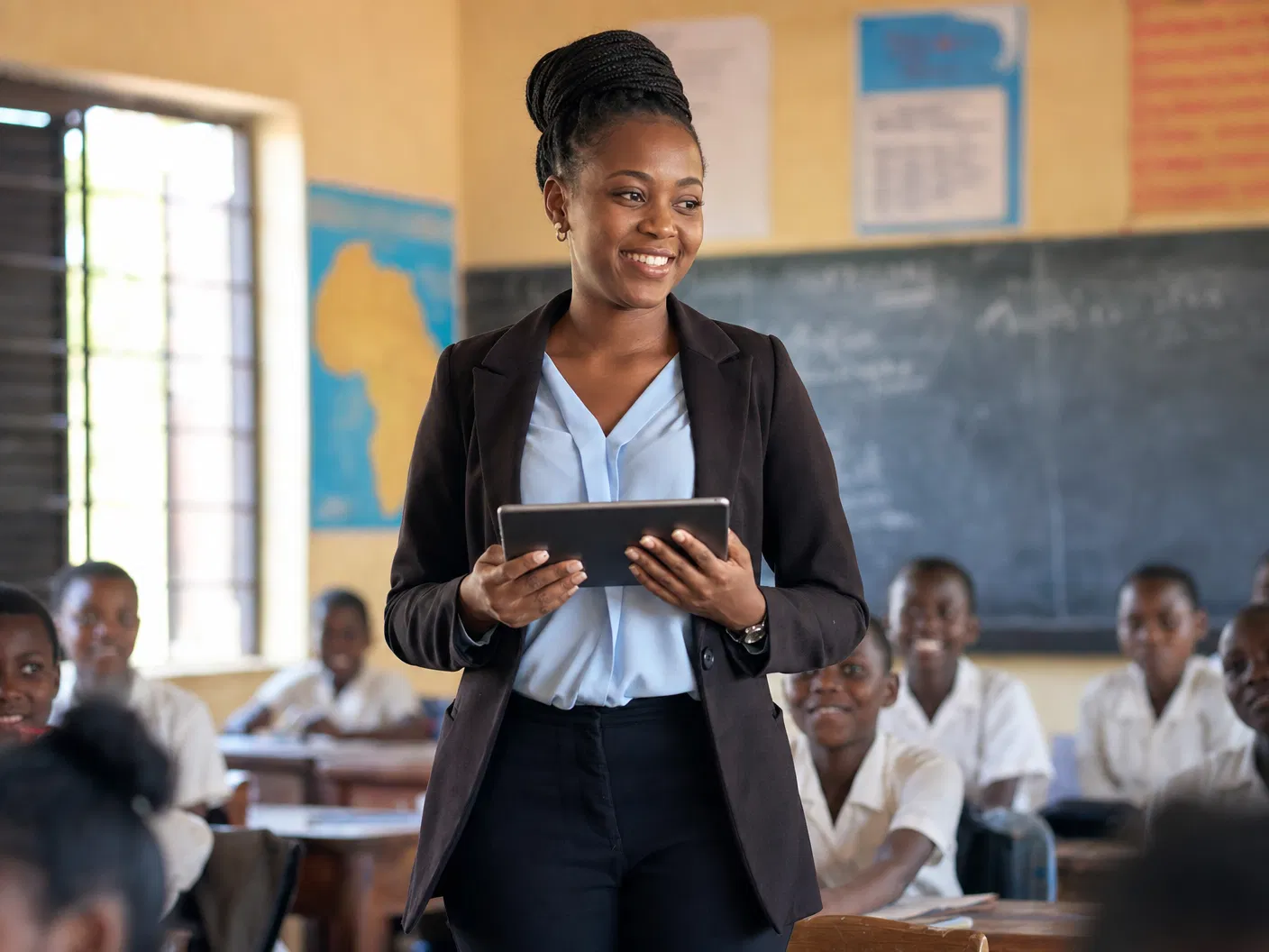 Expert African teacher at interactive whiteboard
