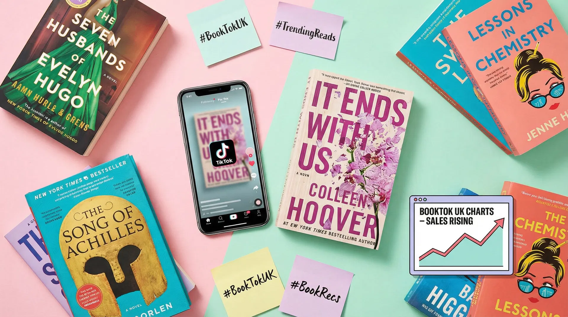 Flat-lay of trending paperback novels with a smartphone showing TikTok book content and BookTok hashtag sticky notes