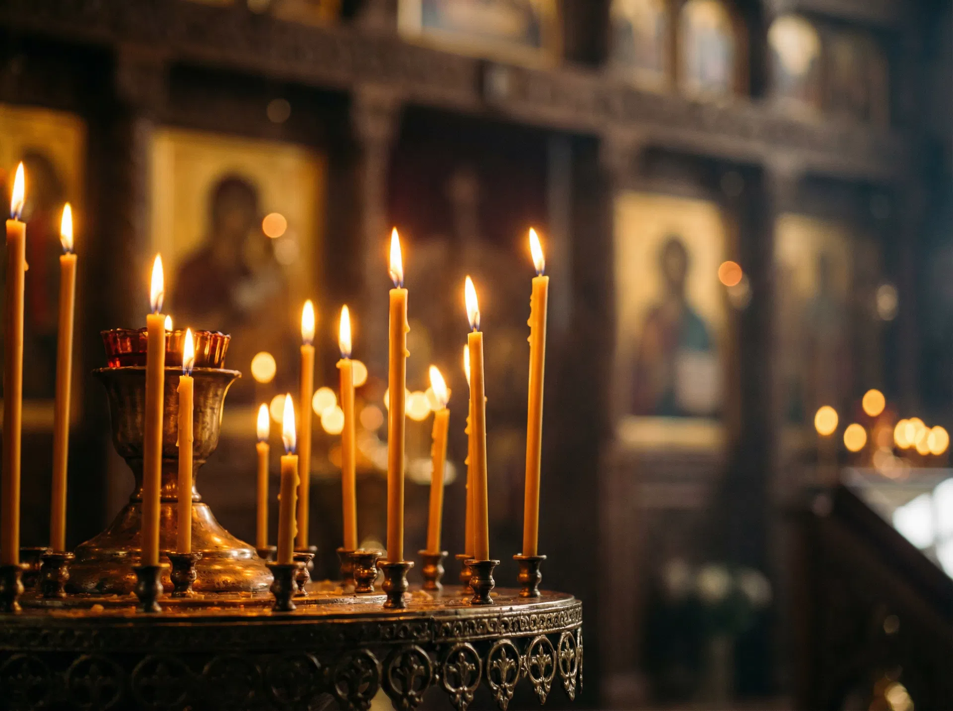 Golden candles burning in an Orthodox church