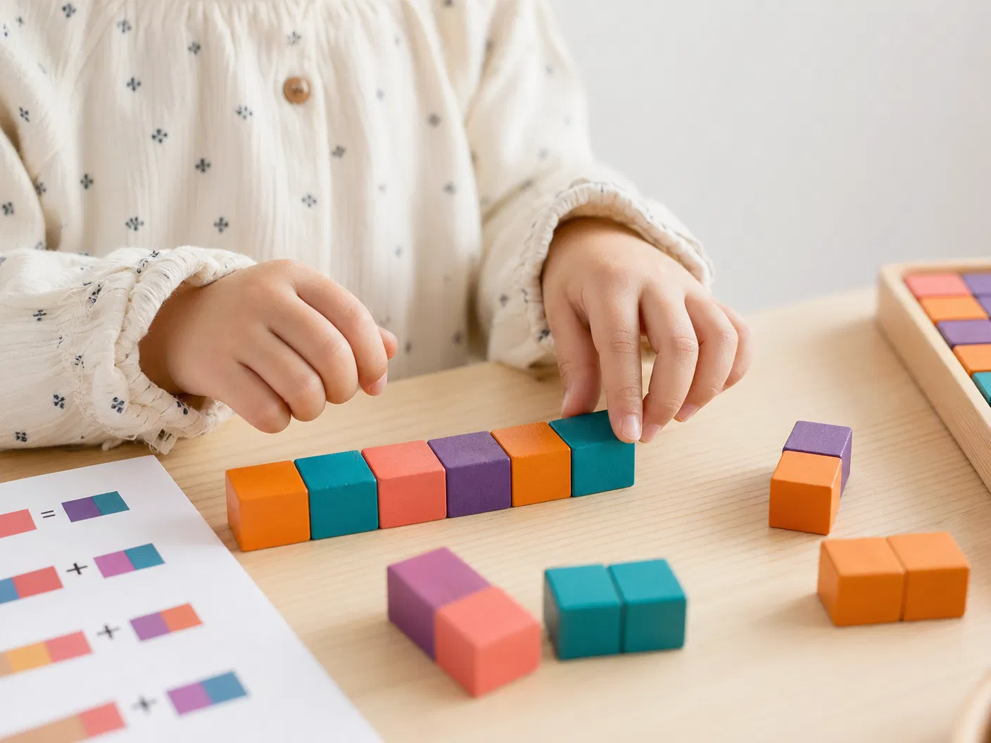 Child working with colorful mathematical manipulatives