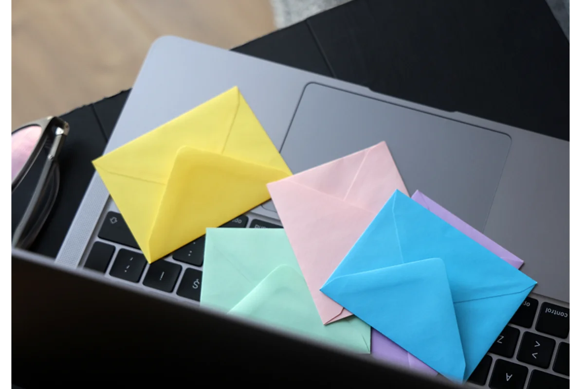 colored envelopes sitting on a laptop