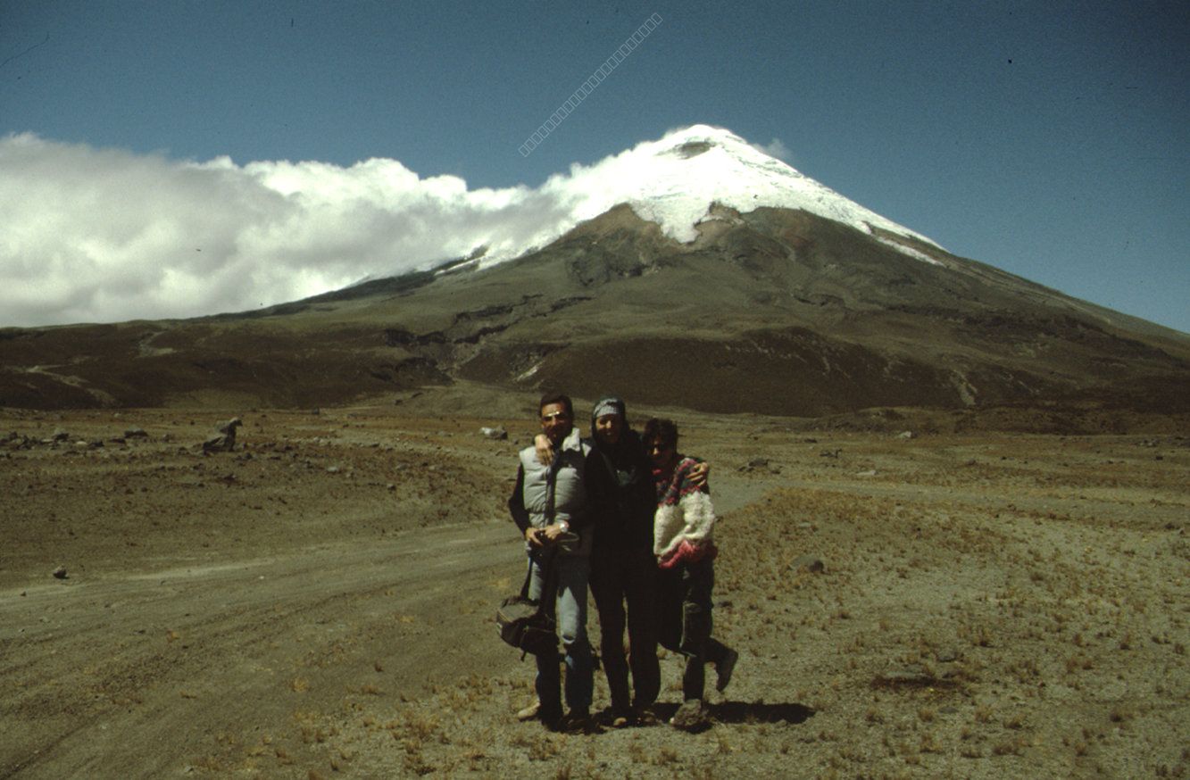Three Travelers in front of the Cotopaxi Volcano in Ecuador