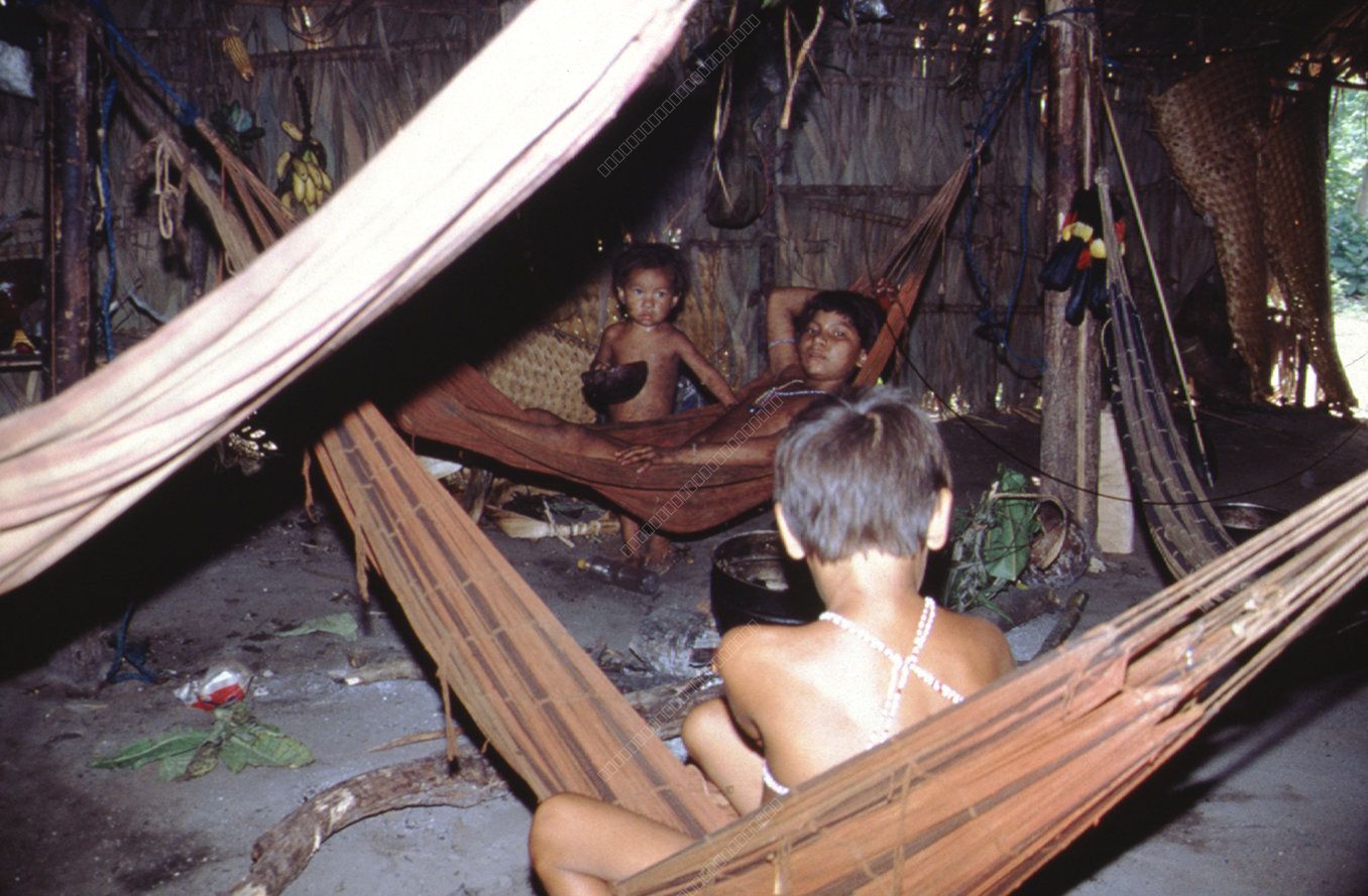 Indigenous Family in Hut with Hammocks