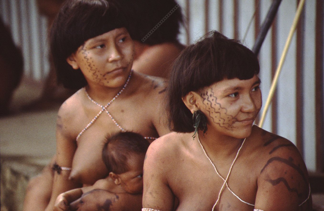 Indigenous Women with Child, Adorned with Traditional Body Painting