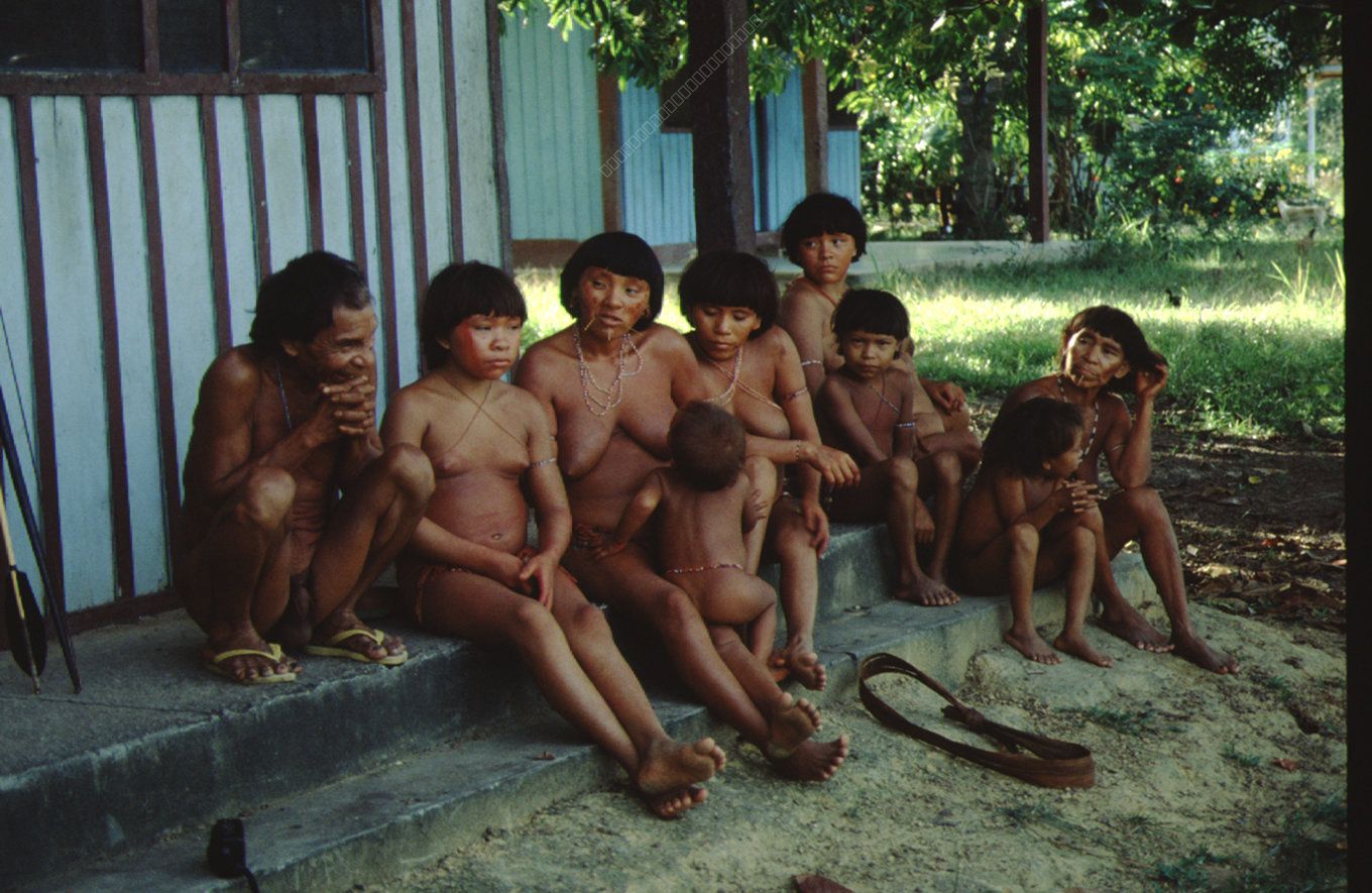 Indigenous Family in Front of a Hut in the Amazon Region