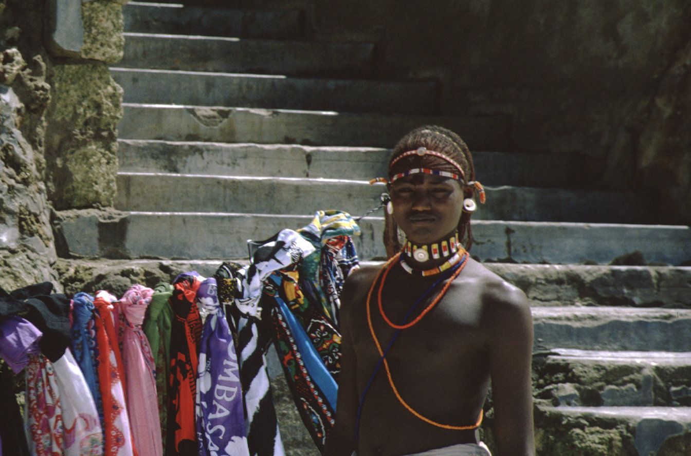 Seller of Beach Towels in Traditional Attire in Mombasa