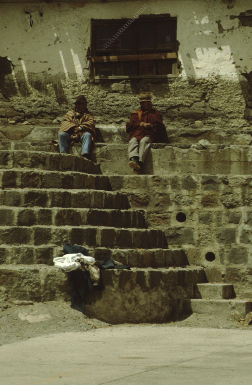 Two Men in Traditional Clothing on Stone Steps