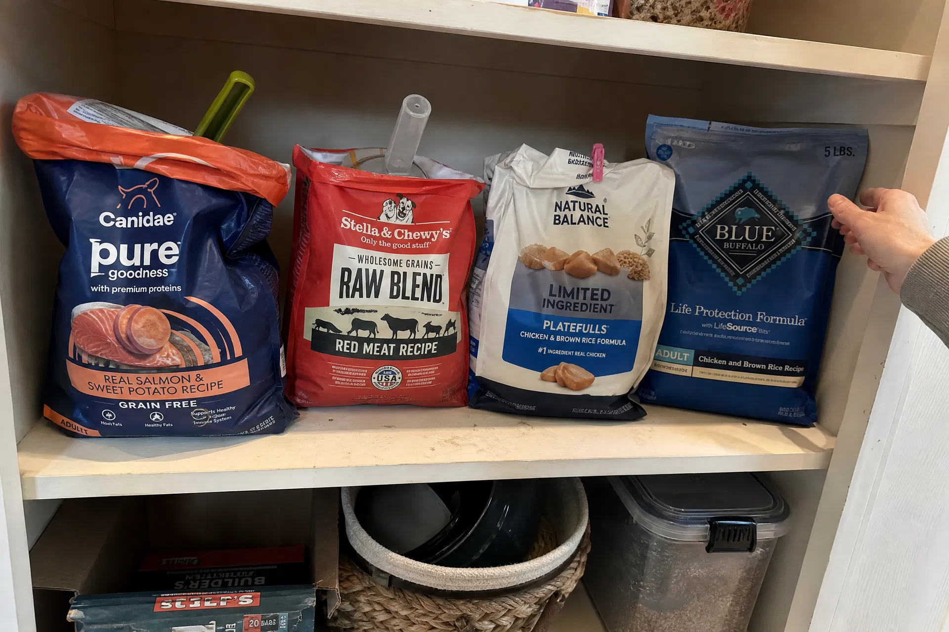 Dog food bags opened on pantry shelf
