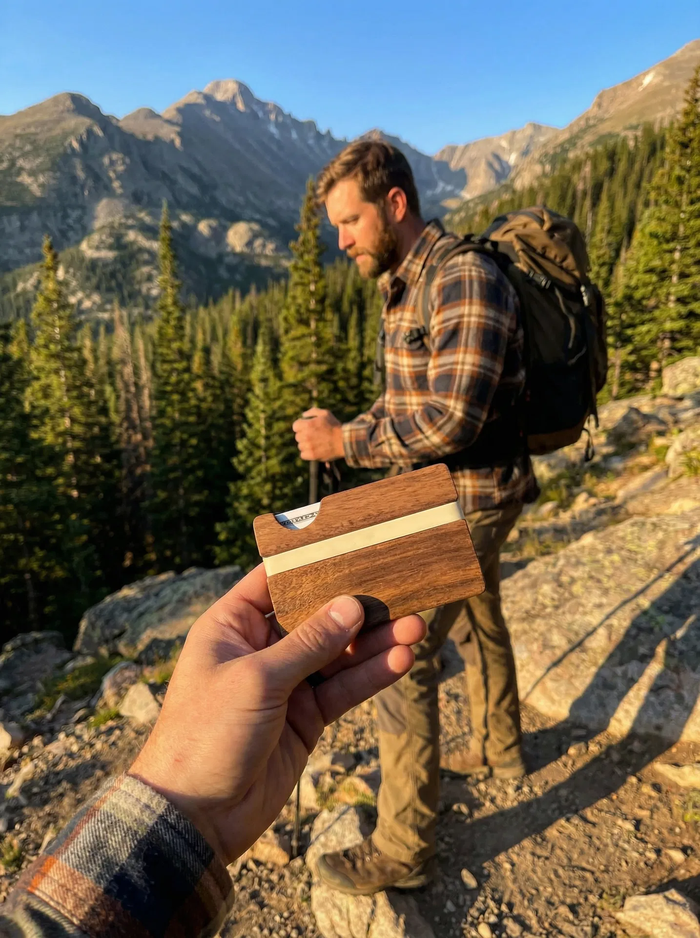 Hiker examining Tomi Wallet on Colorado mountain trail