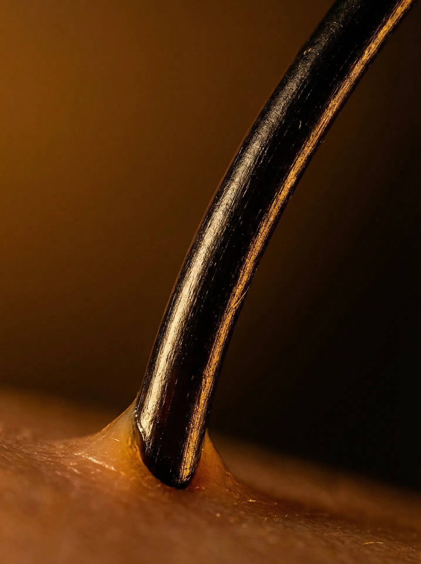 Ultra-macro close-up of a healthy hair strand anchored in follicle