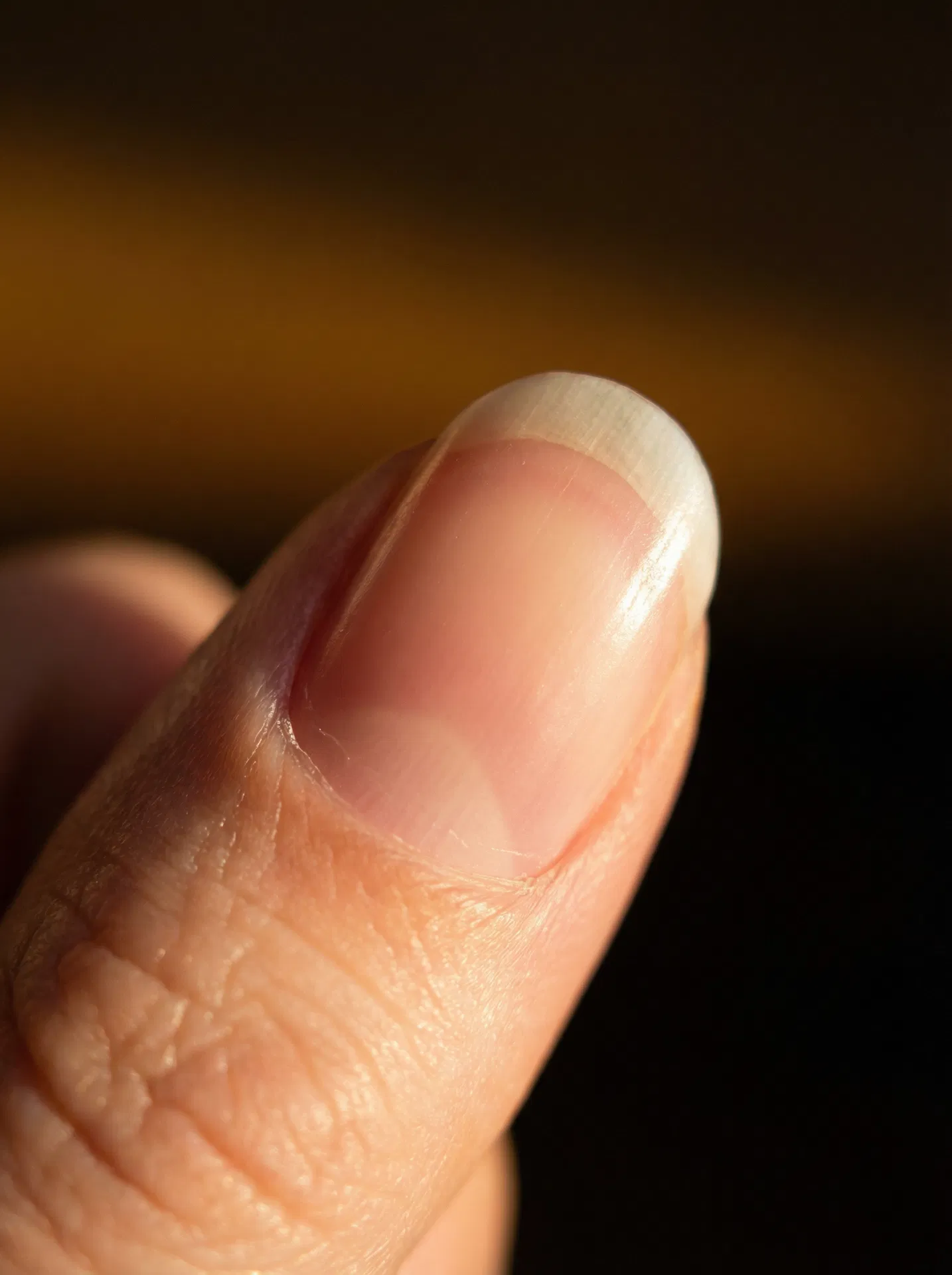 Ultra-macro close-up of a strong, smooth fingernail