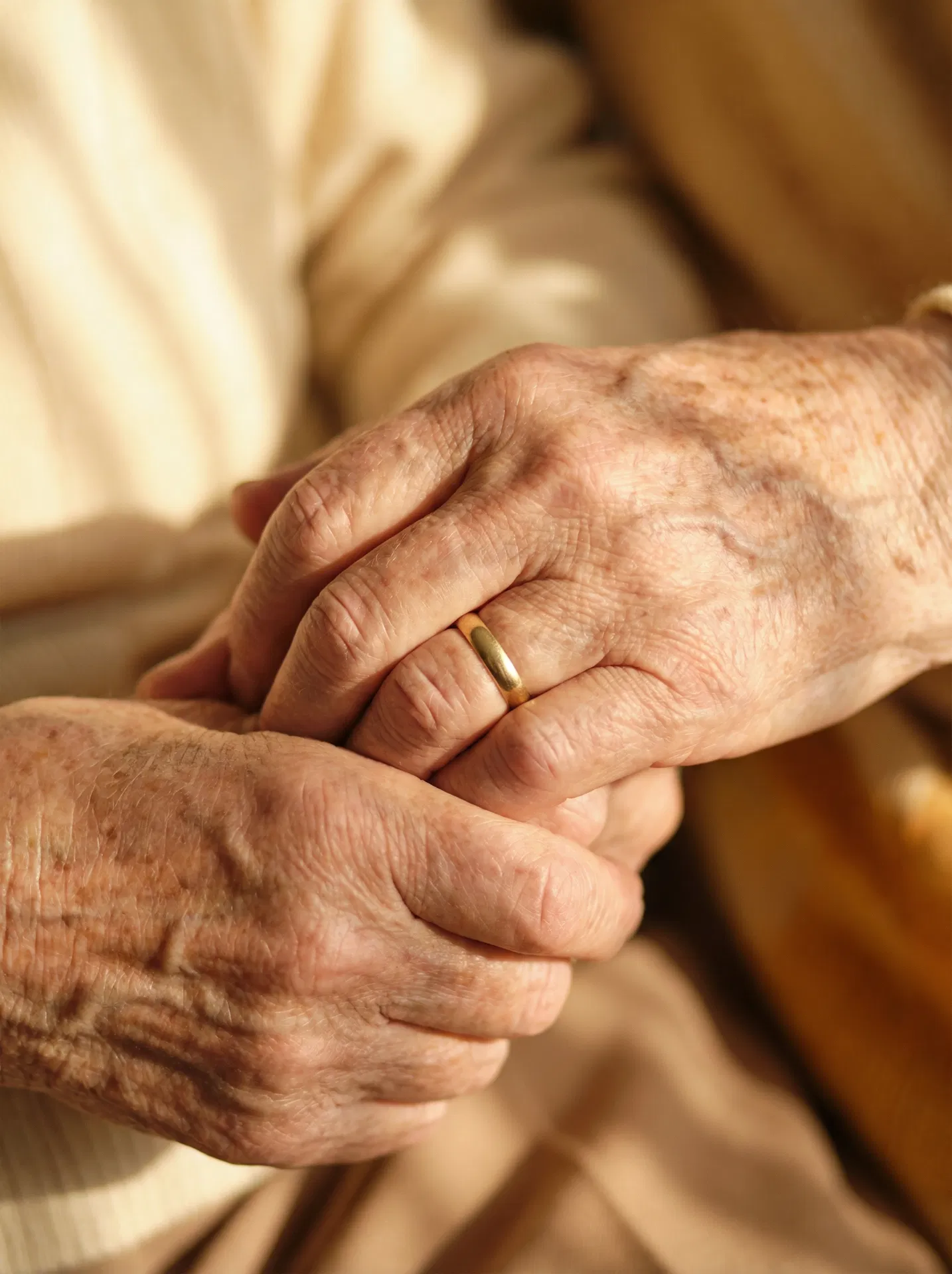 Elderly couple holding hands — representing love, legacy, and protection
