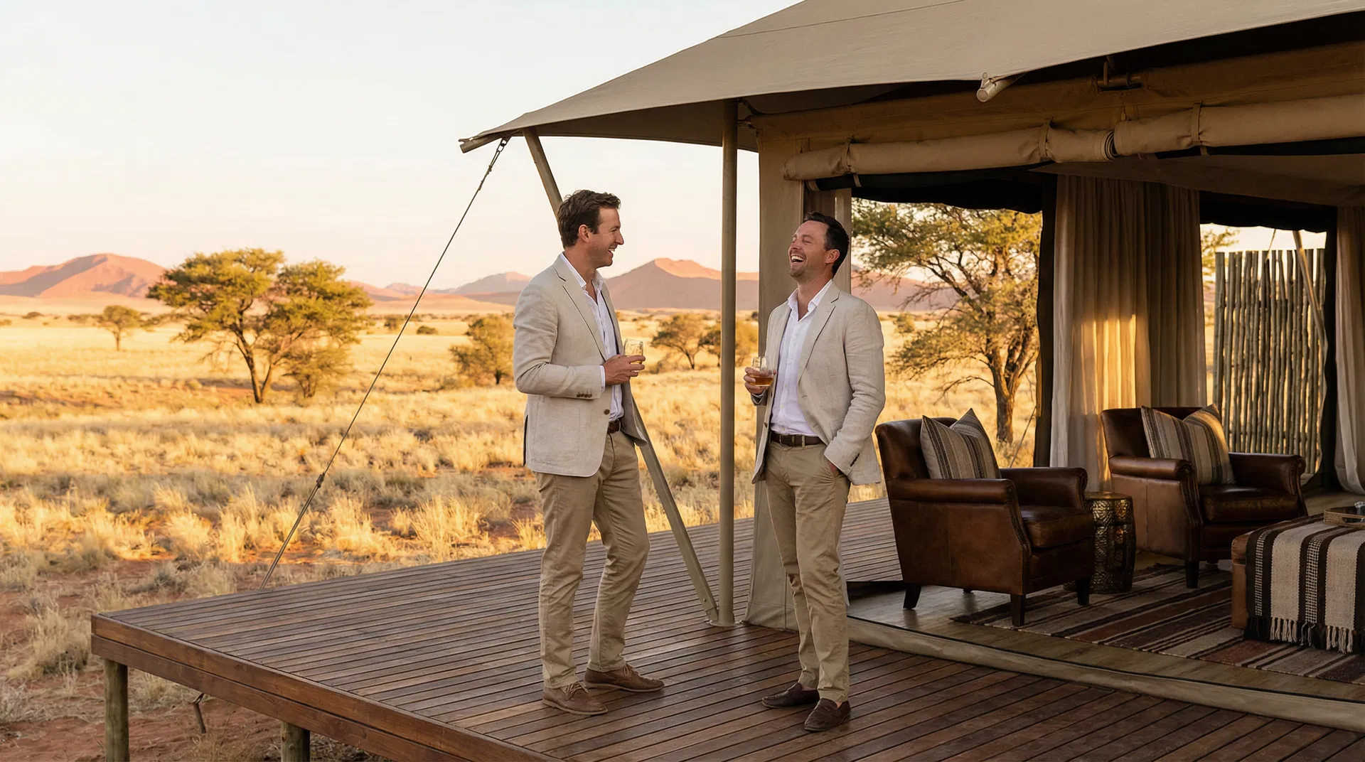 Two men at a luxury Namibia safari camp at golden hour — Two Bad Tourists blog feature on OUT Namibia