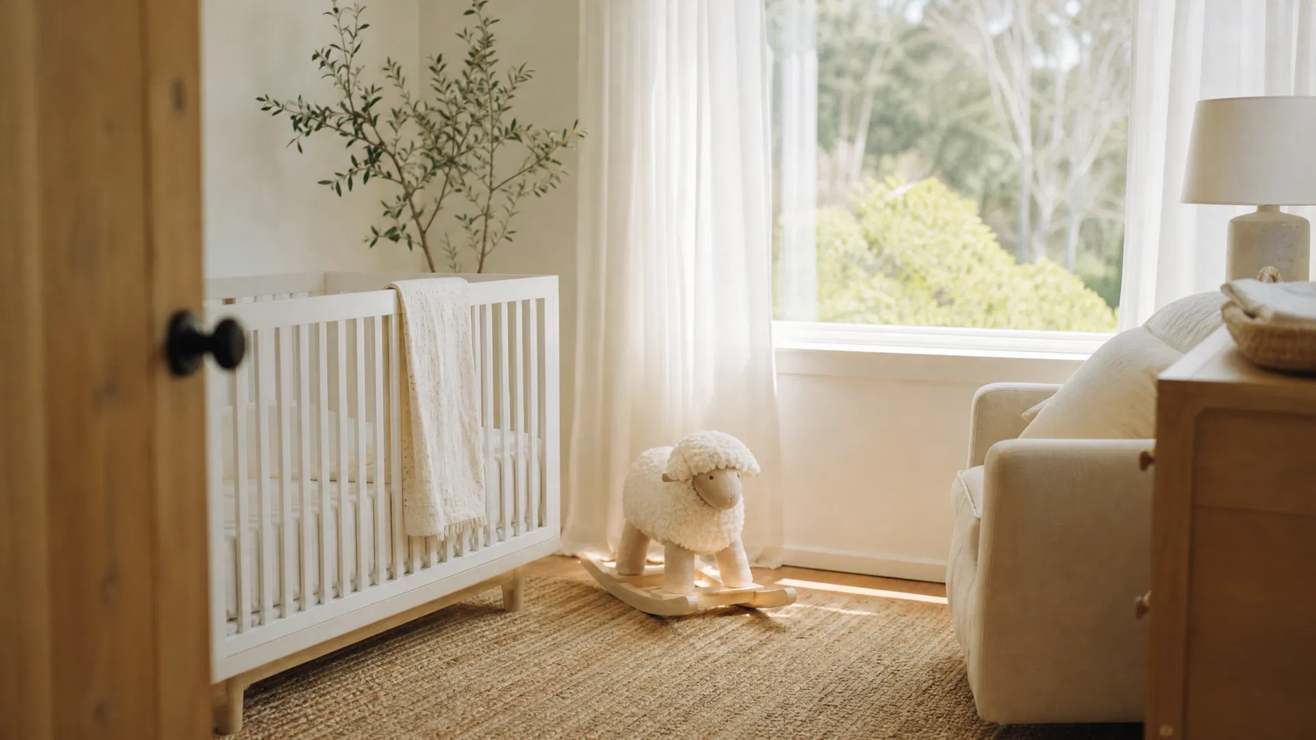 Serene Marin County nursery with white crib, natural wood furniture, and soft morning light