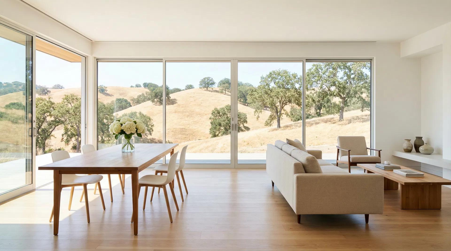 Clean sunlit open-plan living and dining room in modern Novato home with panoramic views of rolling golden Marin hills through large windows