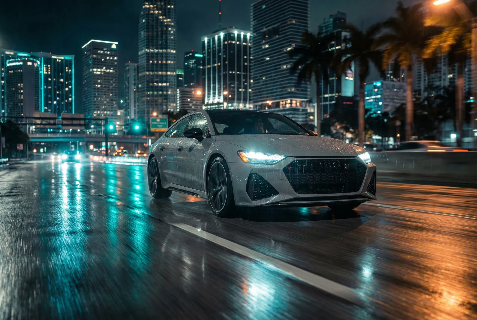 2025 Audi RS7 Sportback lease Miami — wet highway night shot with city skyline