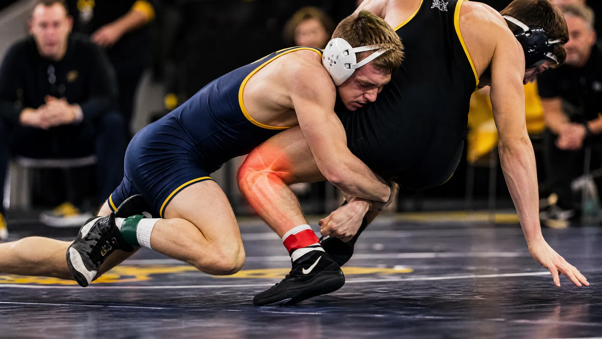 Wrestlers during practice showing knee stress