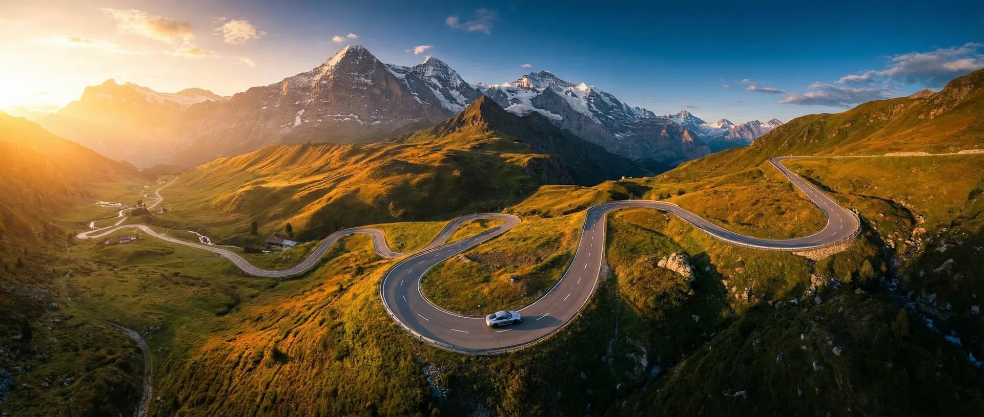 Winding alpine mountain road at golden hour