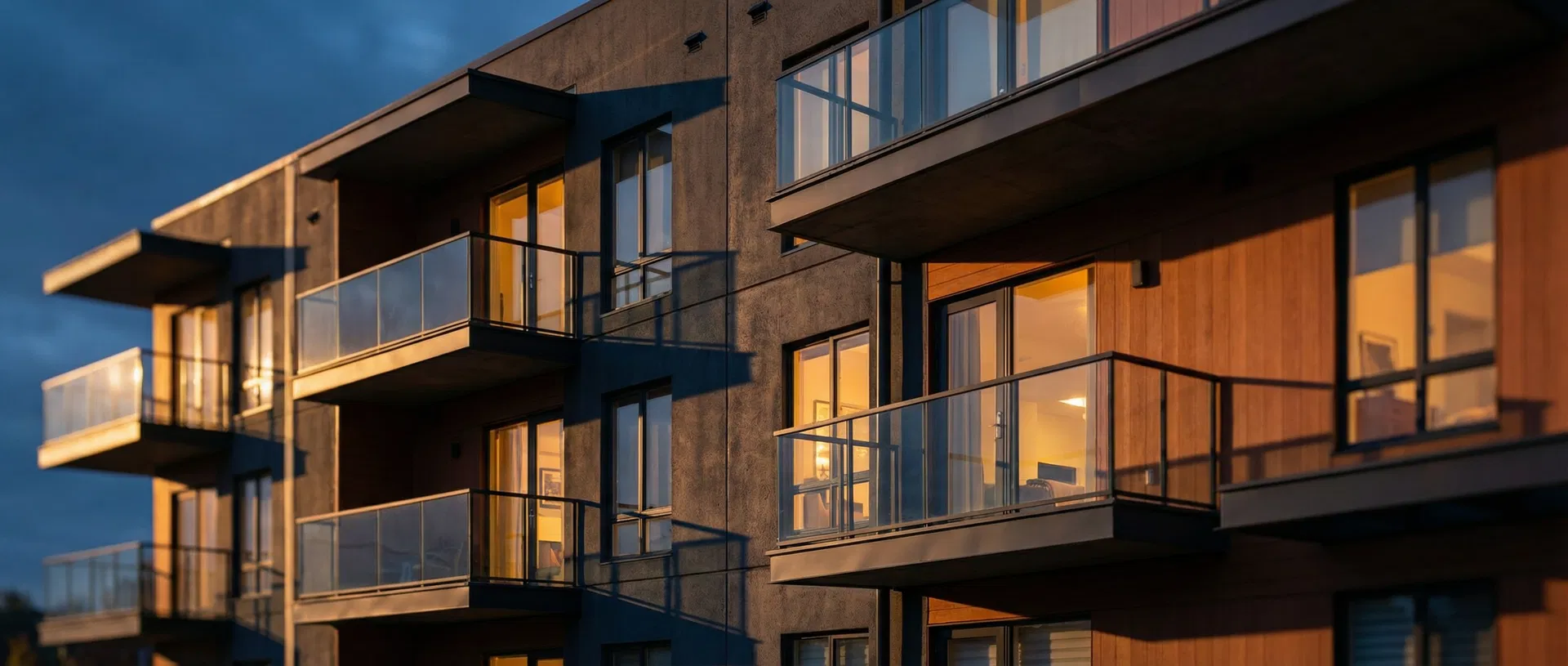 Modern multifamily apartment building at twilight