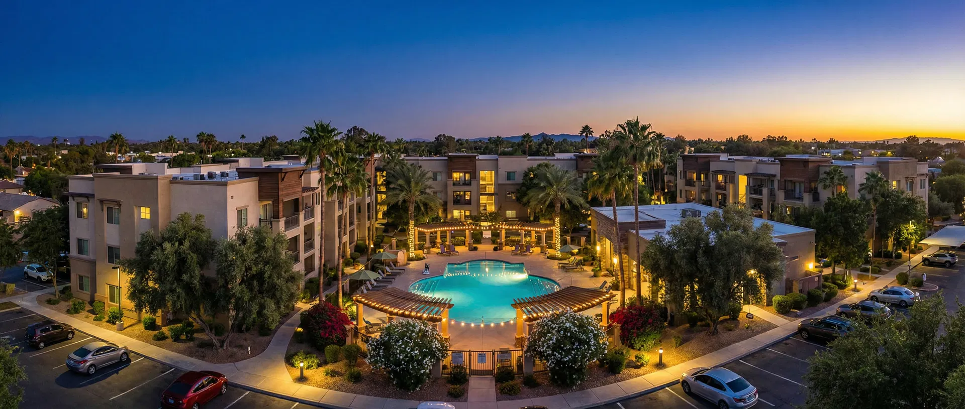 Garden-style apartment community at dusk