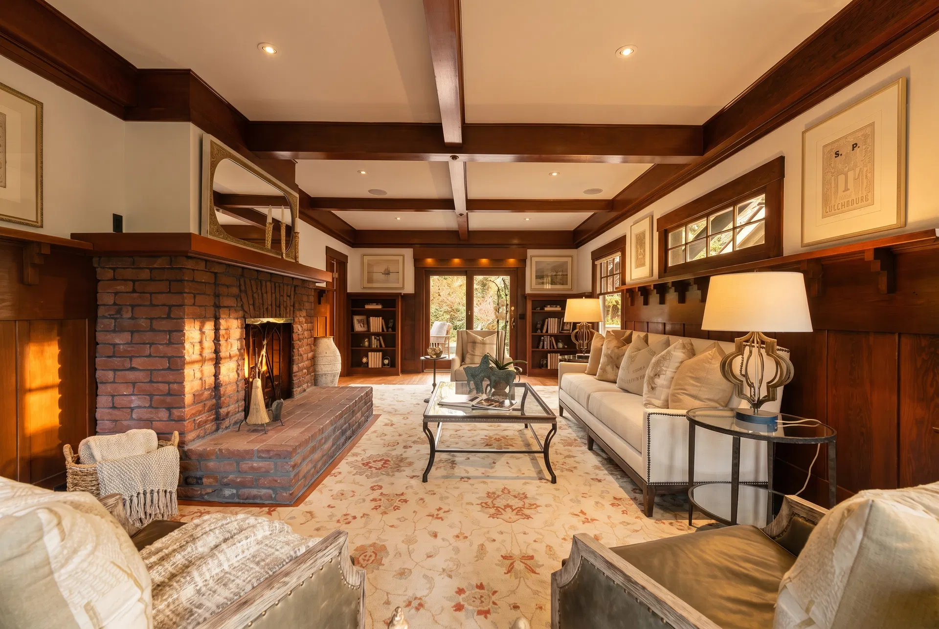 Grand living room with original brick fireplace and coffered ceiling