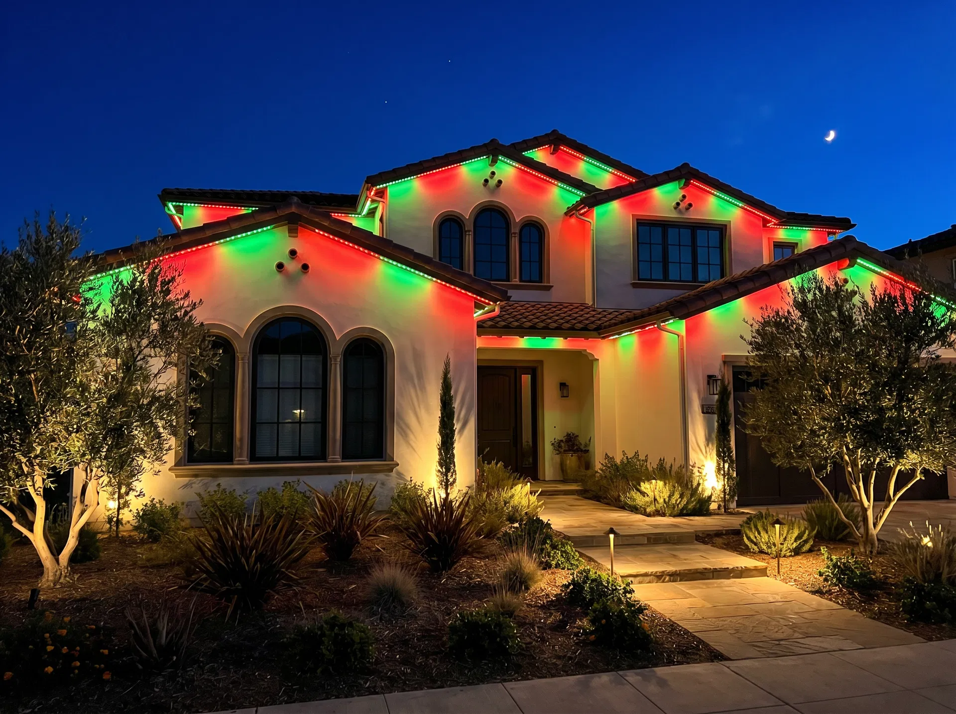 Mediterranean home with red and green holiday LED lighting